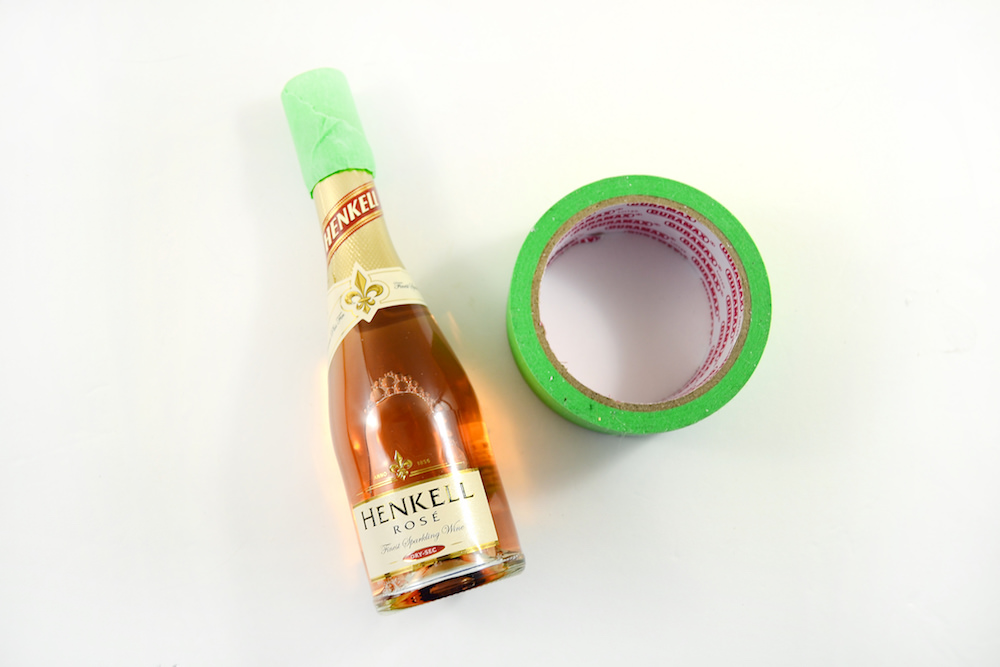 Tape up the top of your mini champagne bottle