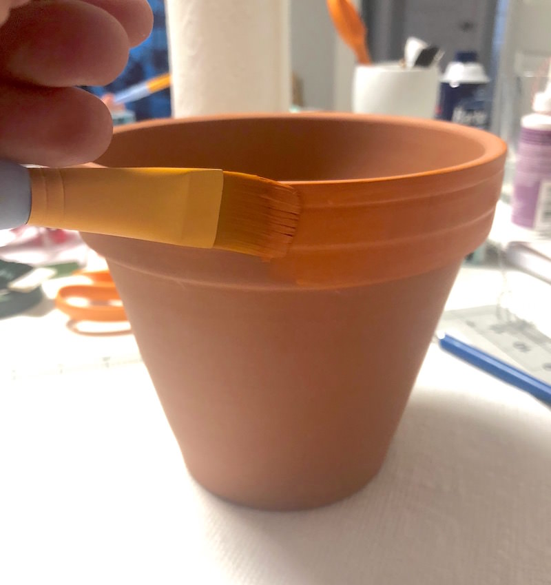 Paint the lip of a clay pot