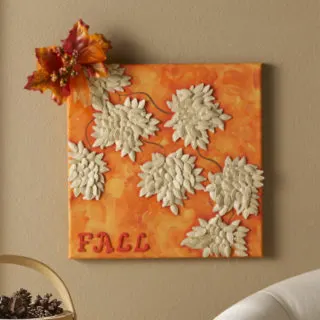 Make a fall canvas with pumpkin seeds
