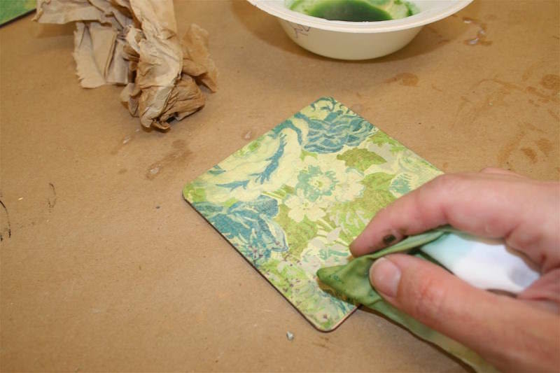 Add alcohol ink to the edges of a coaster with a paper towel