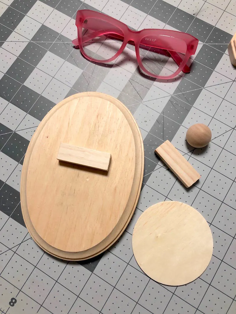 Wood plaque, two small wood pieces, a wood ball, and a wood circle