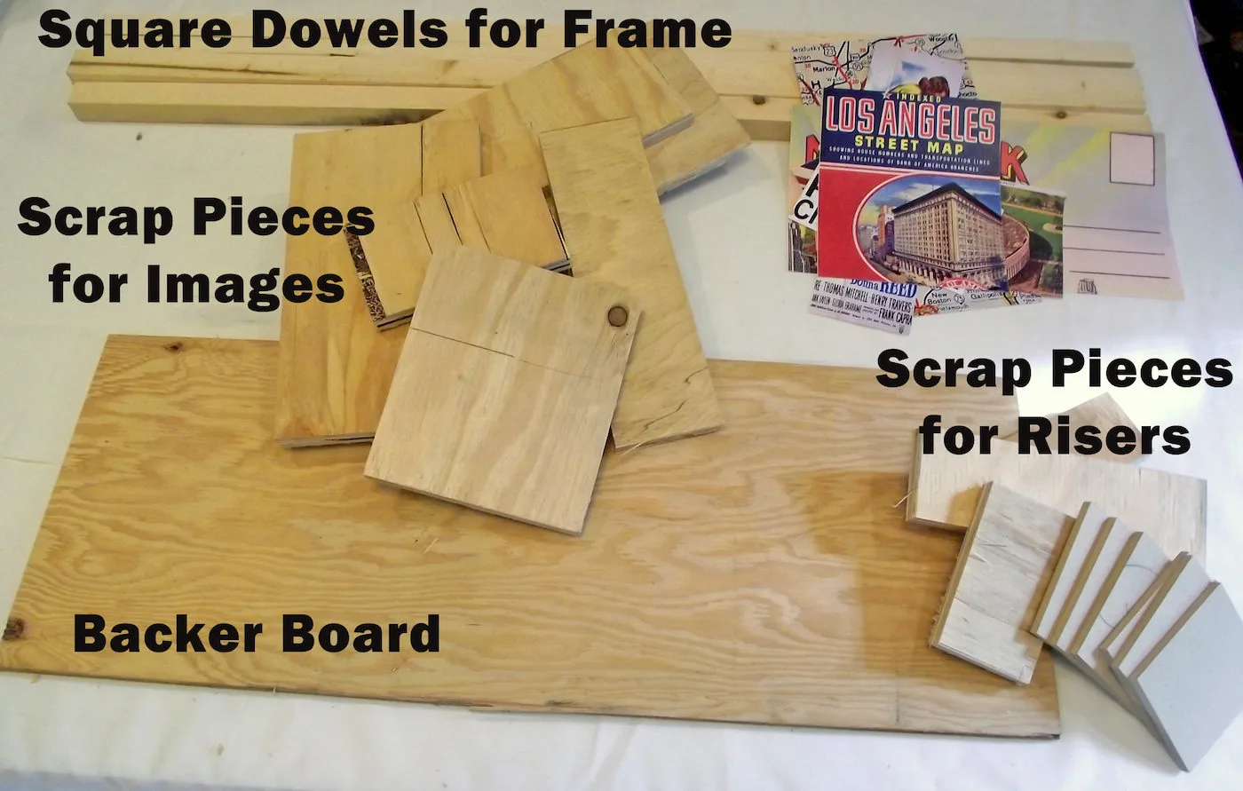 scrap wood, backer board, square dowels, and printed art