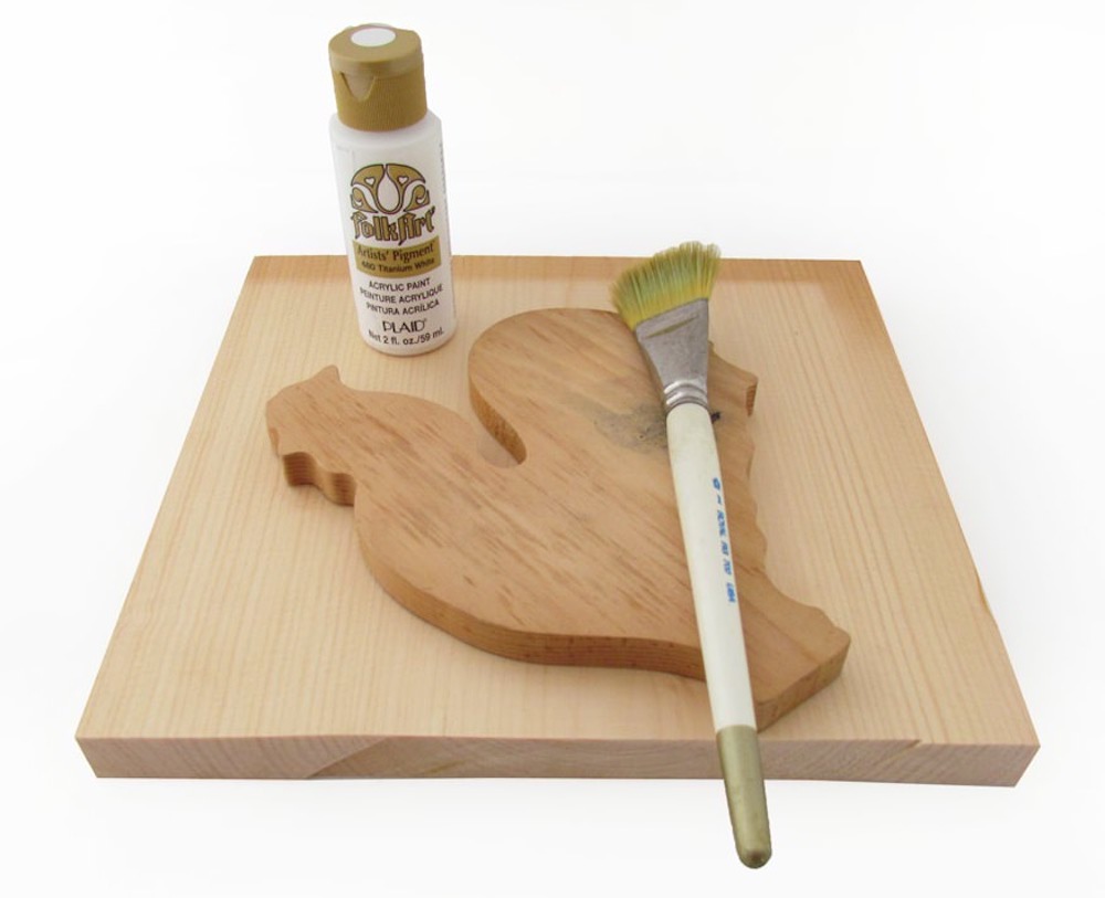 Wood square, wood rooster shape, paintbrush, and bottle of white acrylic craft paint