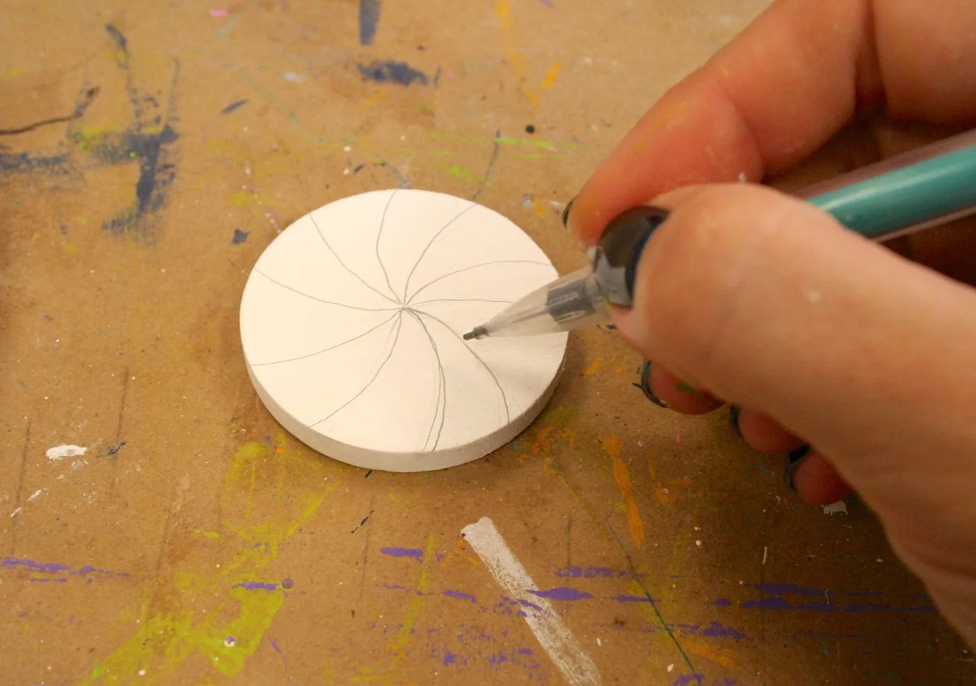 Drawing a peppermint pattern on top of a wood circle