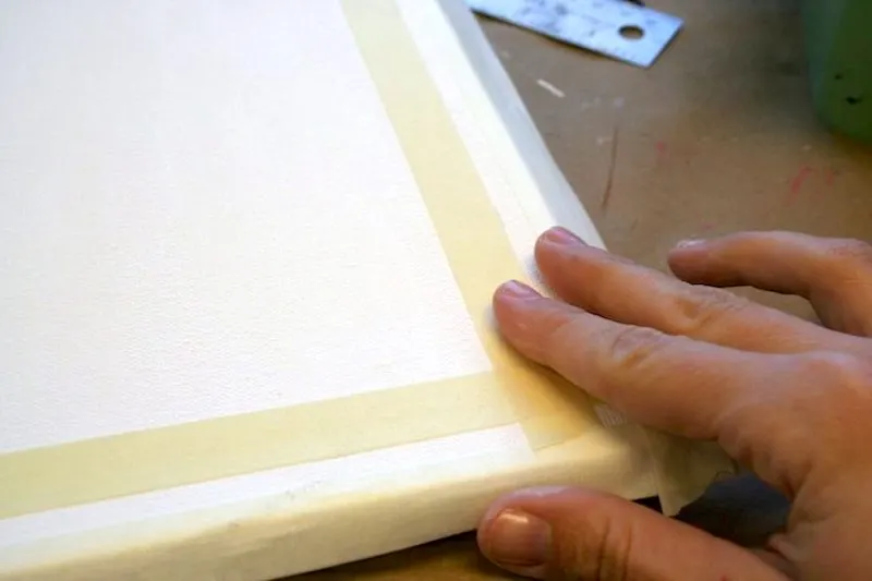 Taping a 1:4 border around a canvas with stencil tape