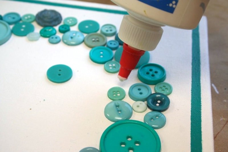 Using craft glue to glue down buttons to a canvas