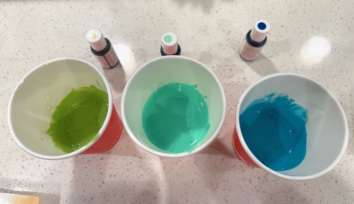 cups of Mod Podge with gel food coloring mixed in