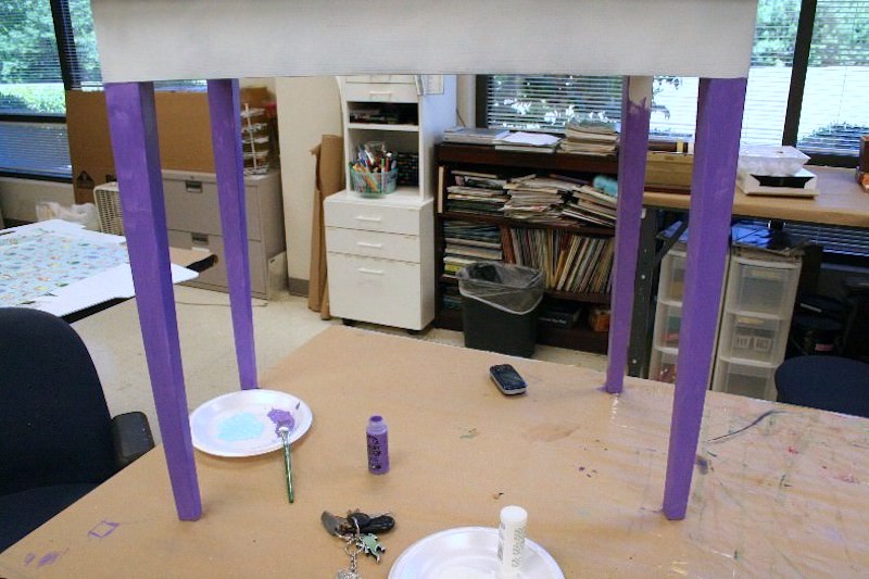 Painting table legs with purple paint