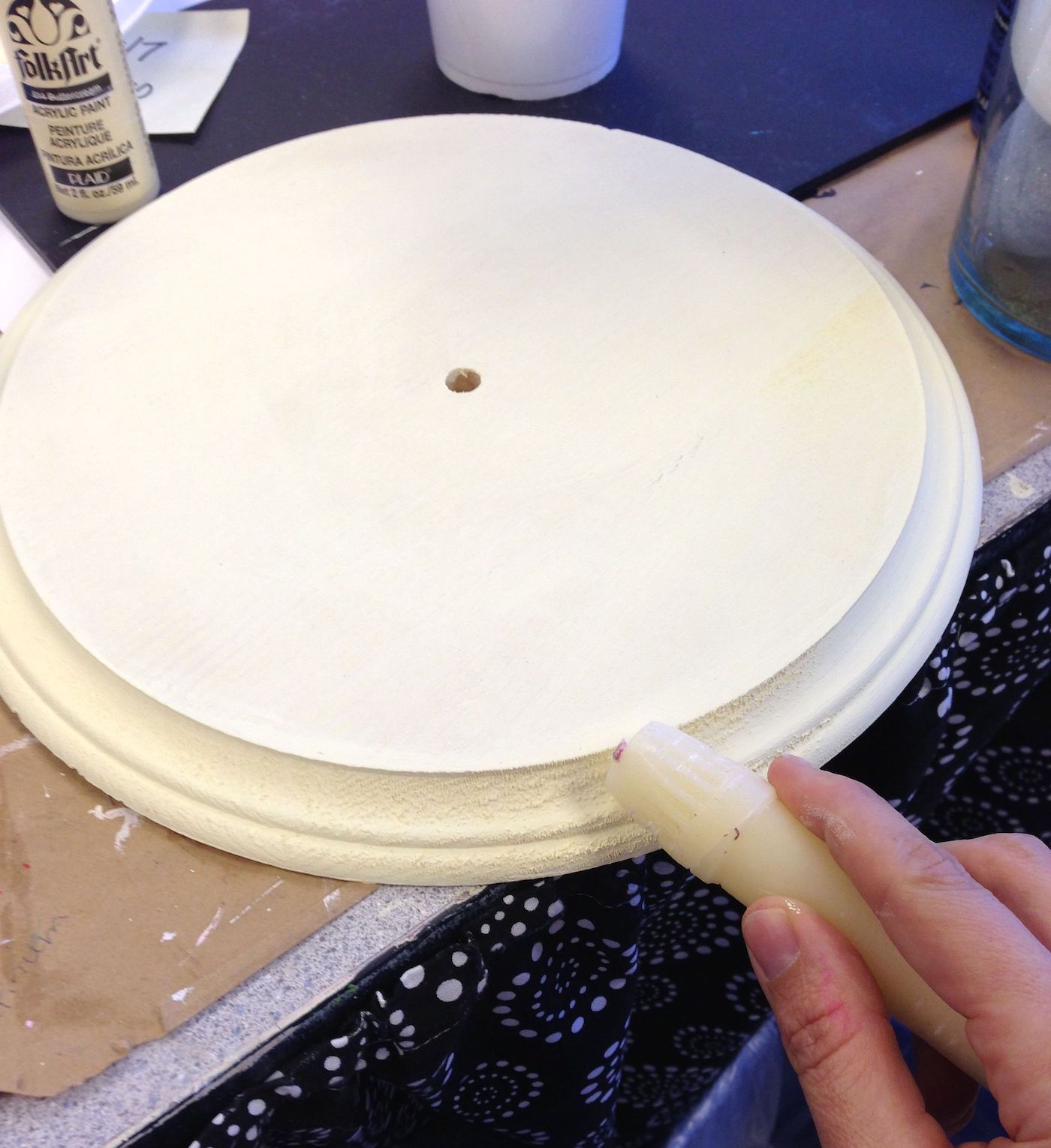 Rubbing the edges of the clock with wax