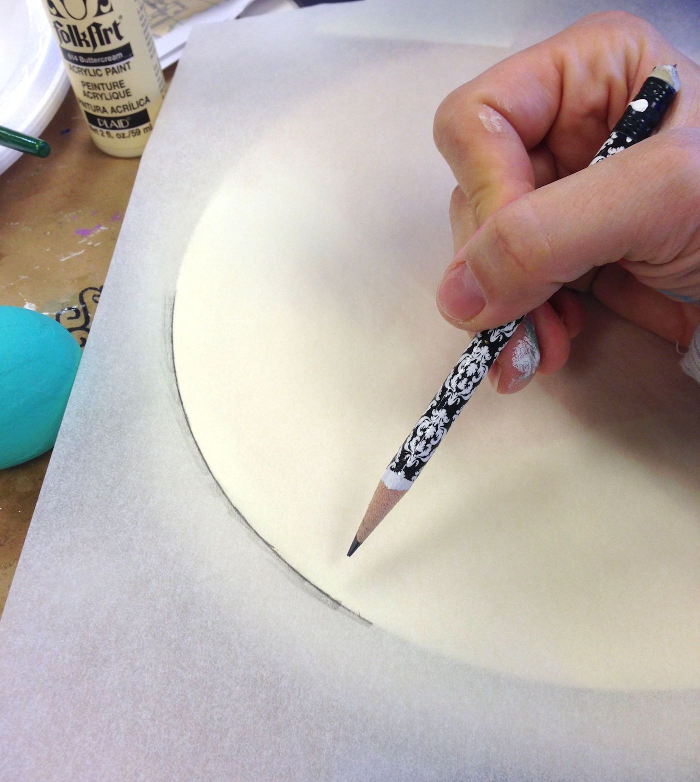 Tracing a clock face with tracing paper and a pencil
