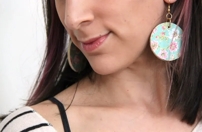 Woman wearing decoupage earrings