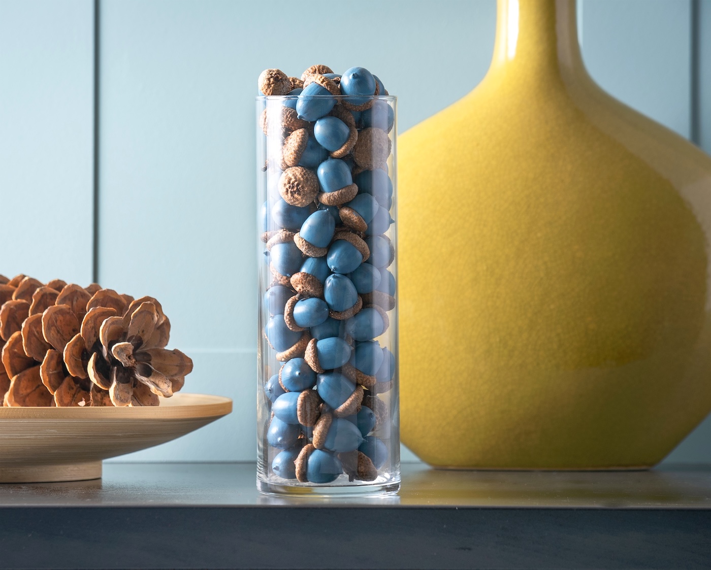 Painted acorns in a glass vase