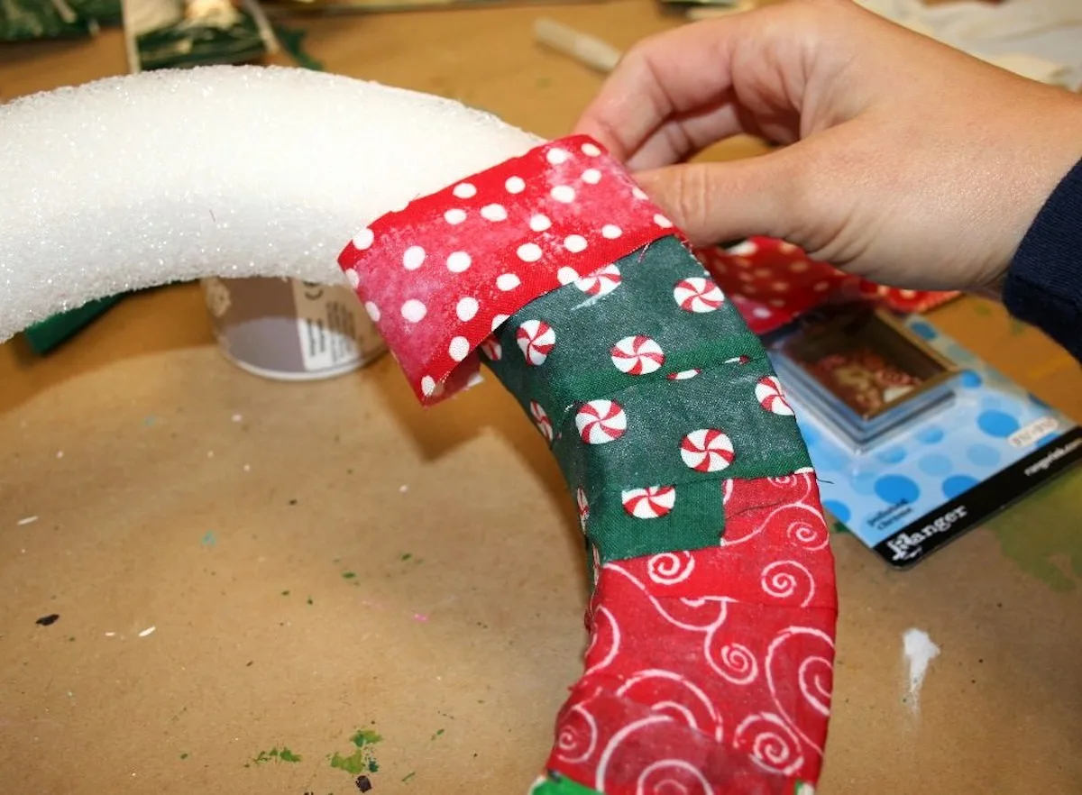 Wrapping the Christmas fabric around the foam wreath form