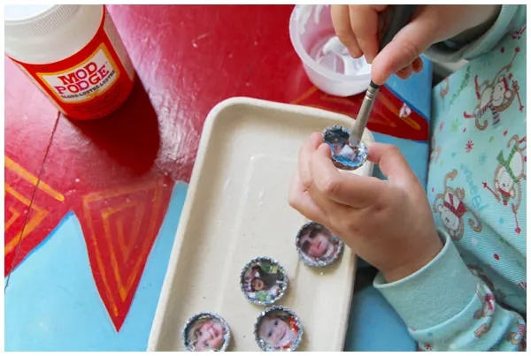 Adding a second coat of Mod Podge to bottle cap magnets