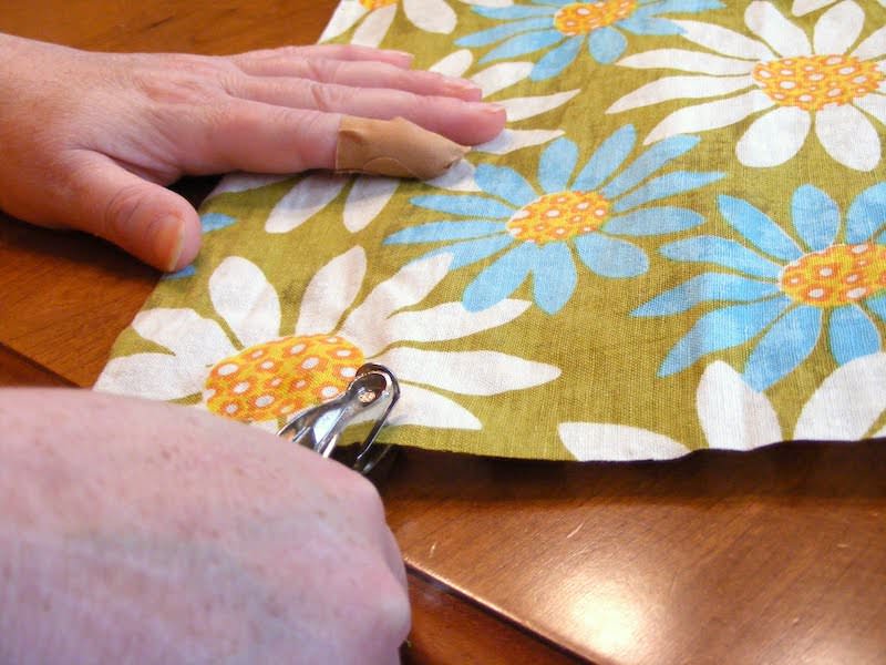 Cutting hardware areas out of fabric with a hole punch