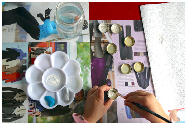 Painting bottlecaps using a paint brush