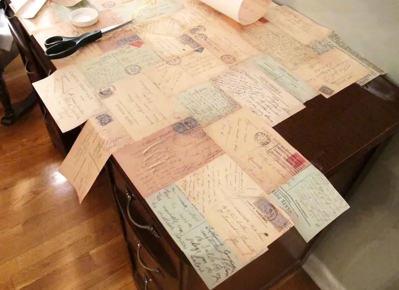 Desk with decoupage postcards on top