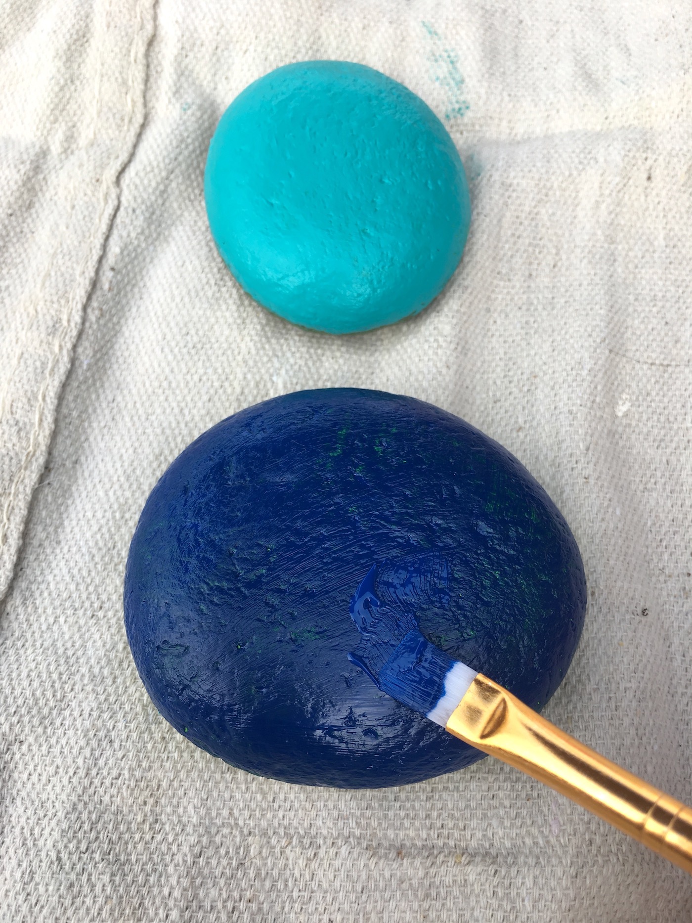 Painting stones in shades of blue and turquoise