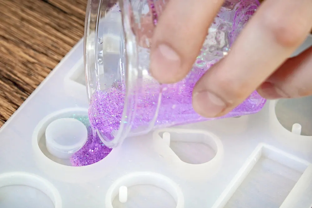 Pouring resin with glitter into a silicone mold