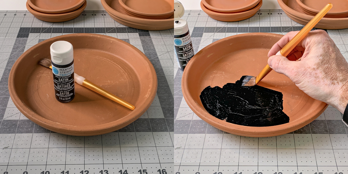 Hand painting black onto a 10 inch clay pot saucer