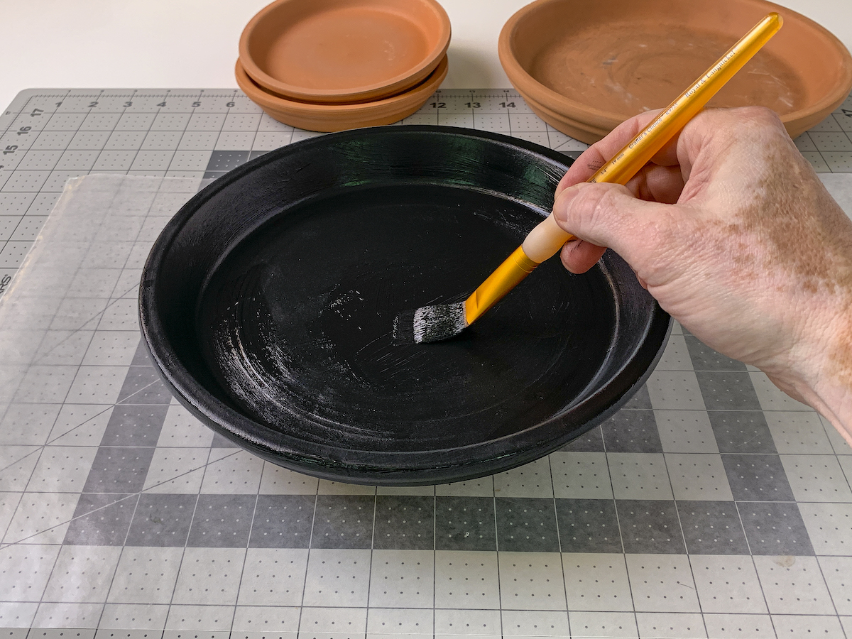 Painting a black saucer with black multisurface paint