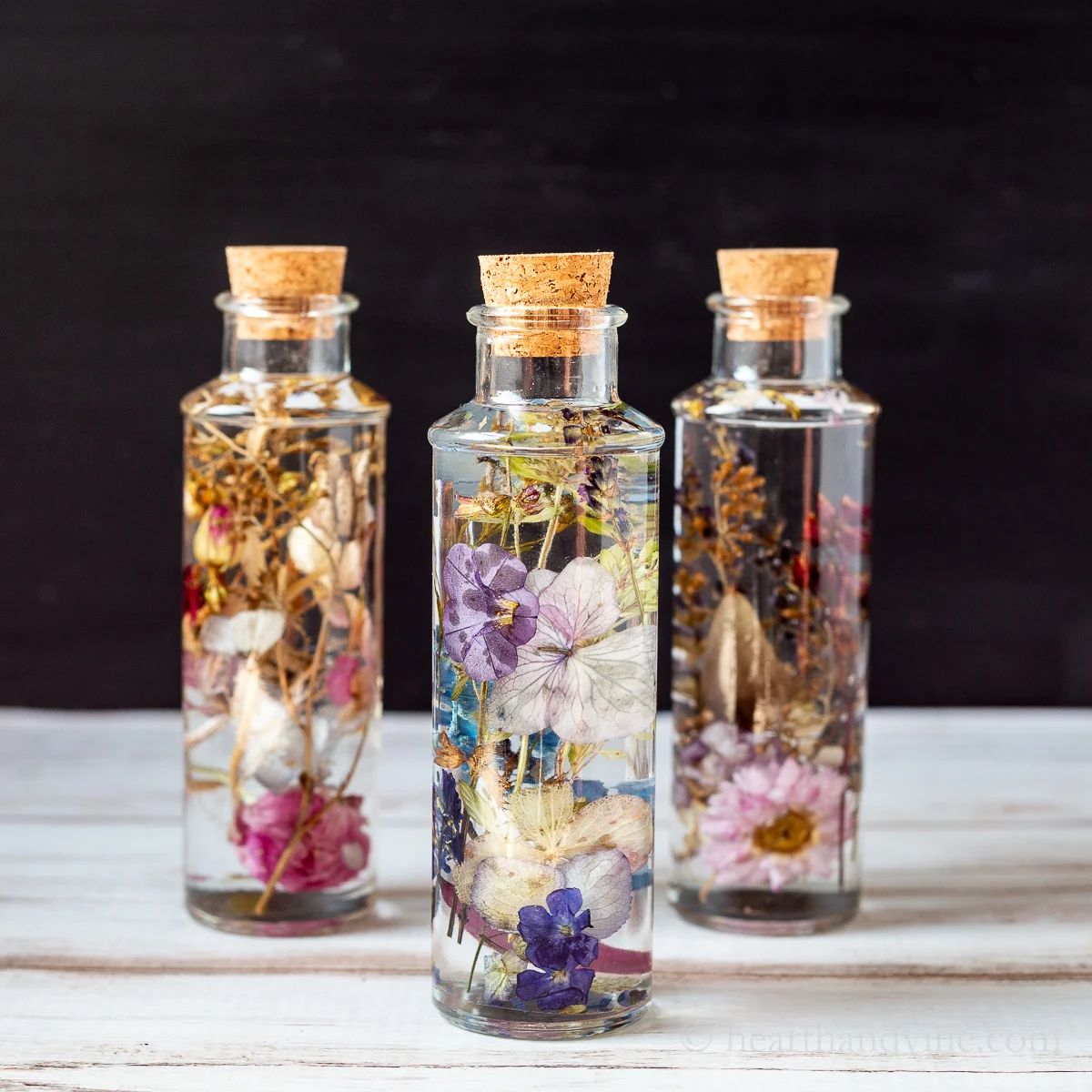 Books and decorative dried flowers in glass bottle Stock Photo by