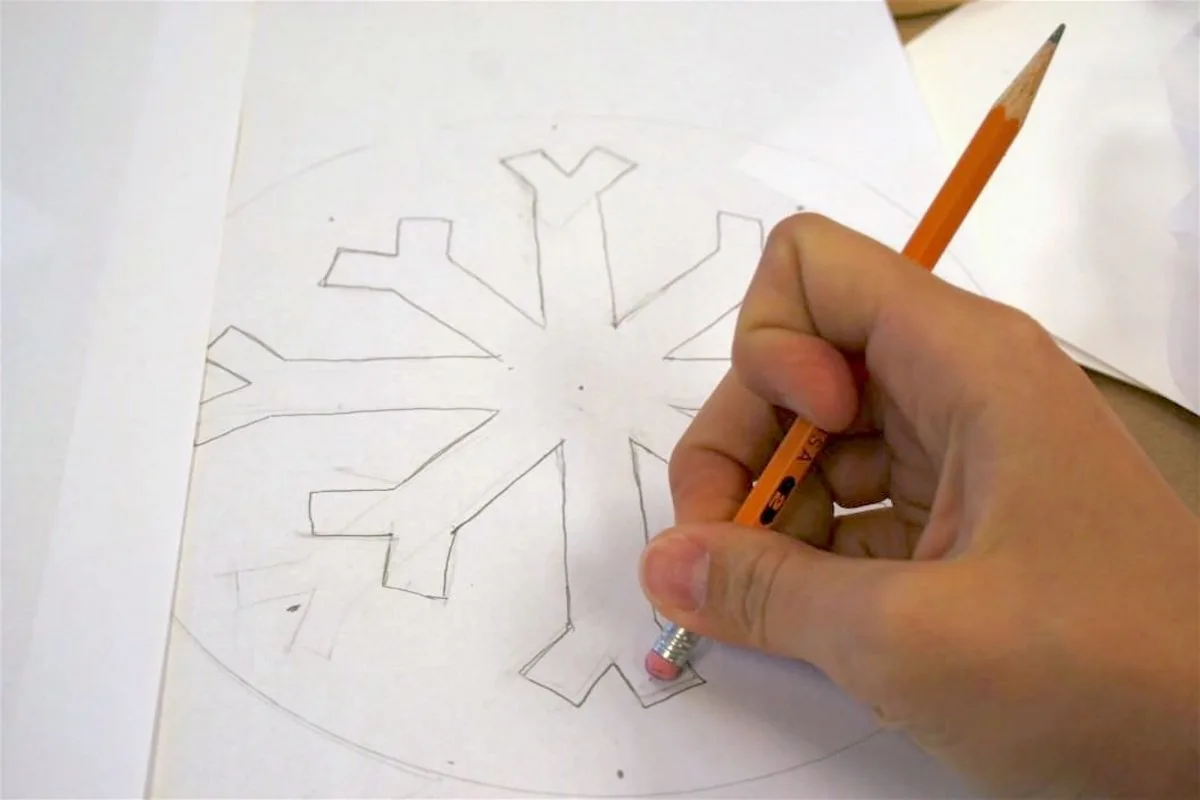 Drawing a design on paper with a pencil