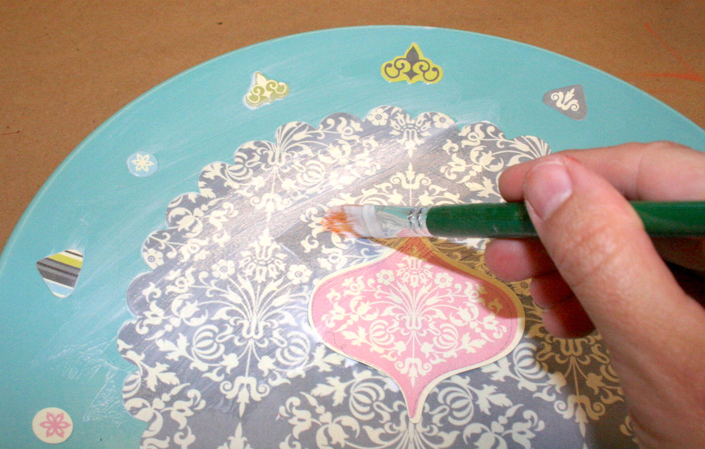 Painting Mod Podge over the top of the plate to seal