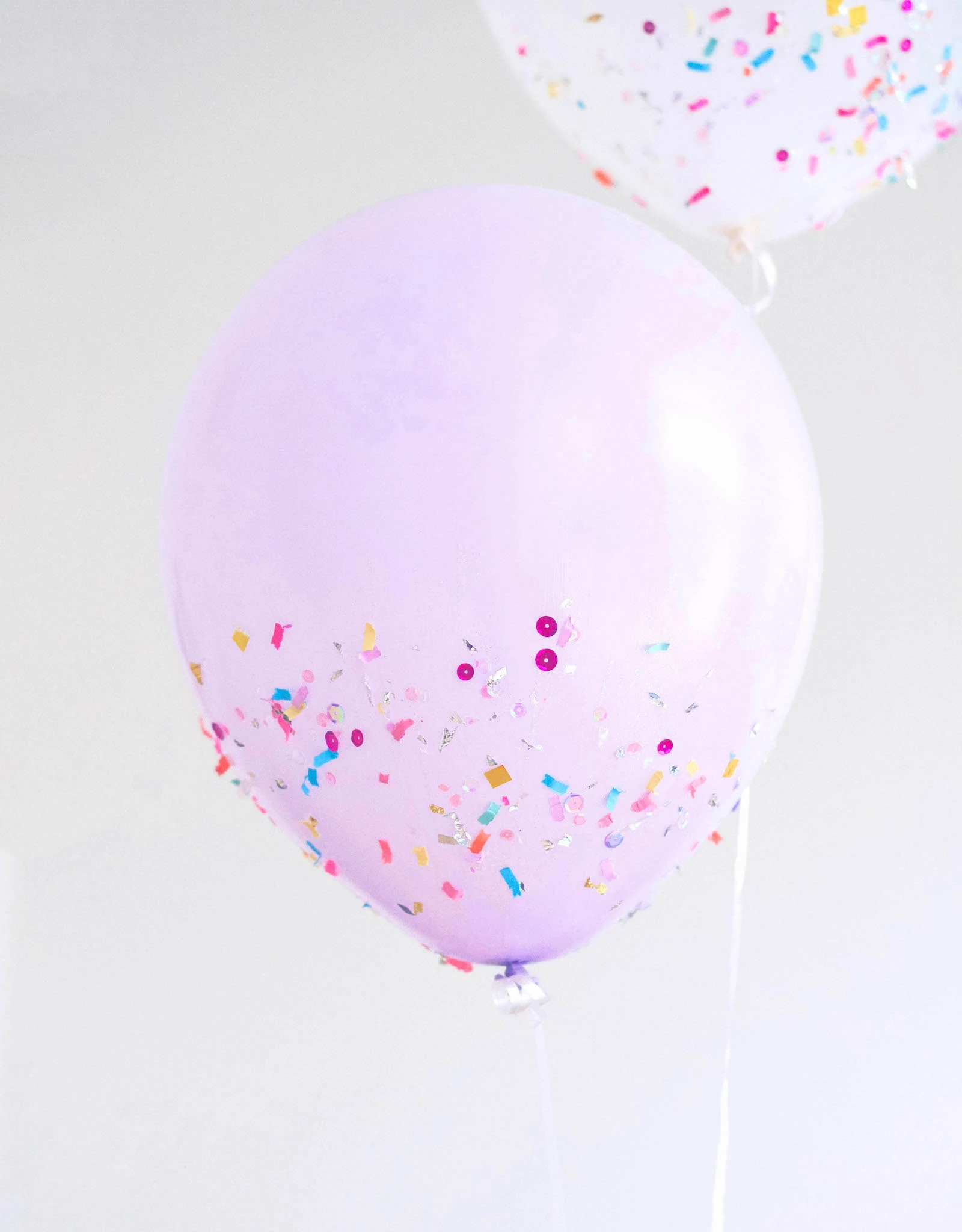 Confetti sprinkled onto a balloon