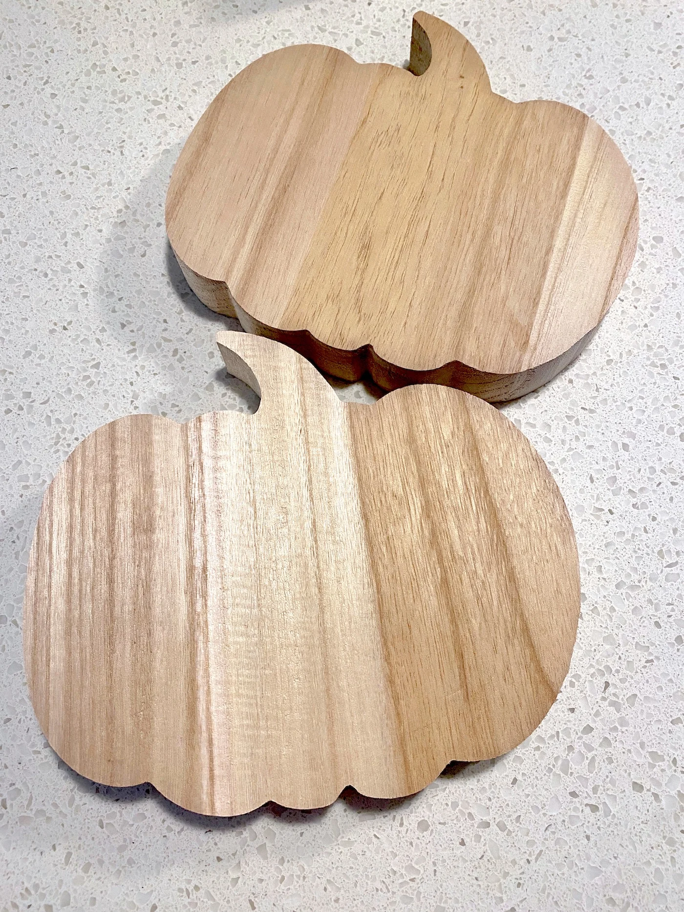 Two unfinished wood pumpkin shapes