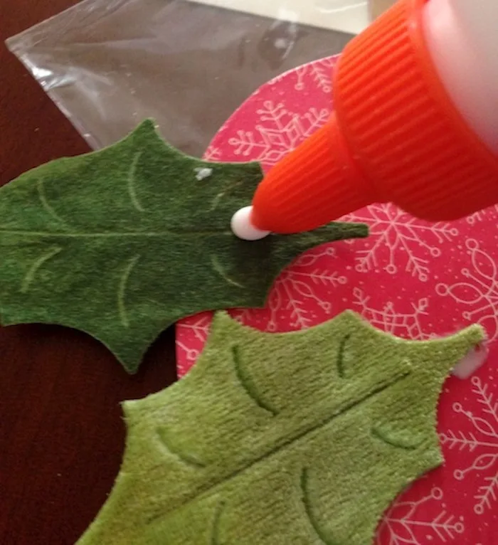 Leaves being glued onto the wood ornament
