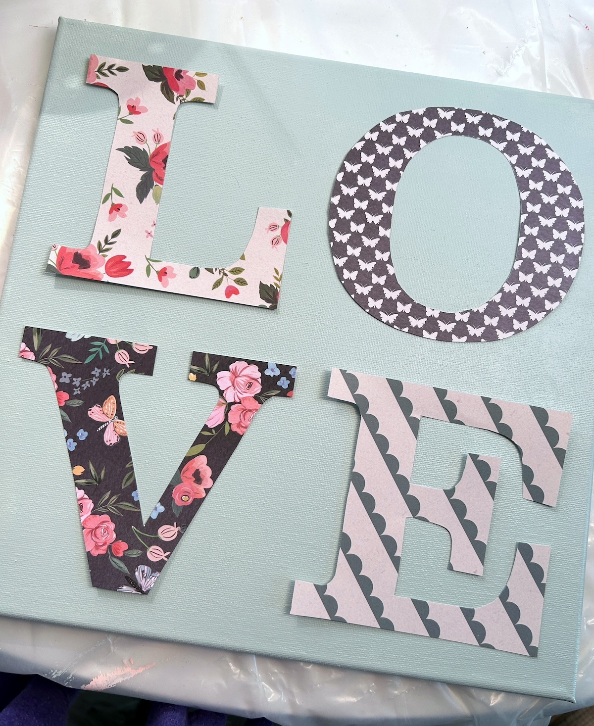 Letters LOVE laid out on a canvas