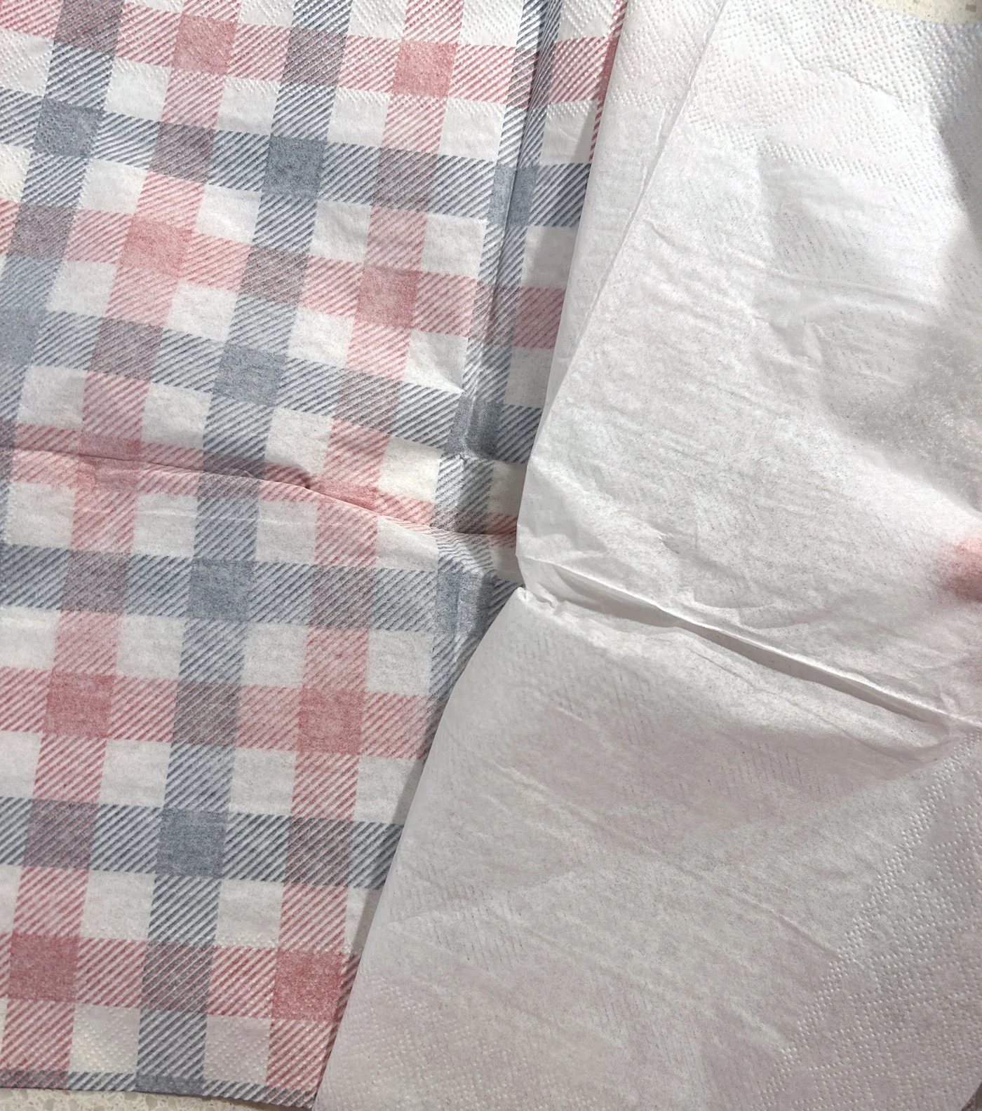 Separating red and blue plaid napkin layers