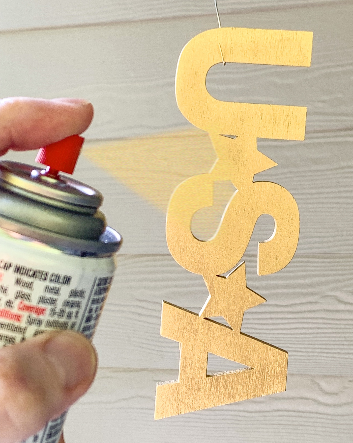 Spray painting the word USA with gold spray paint