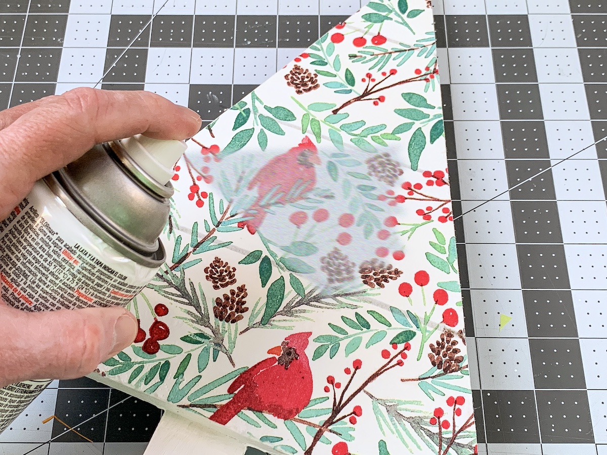 Spraying the holiday napkin and tree with clear sealer