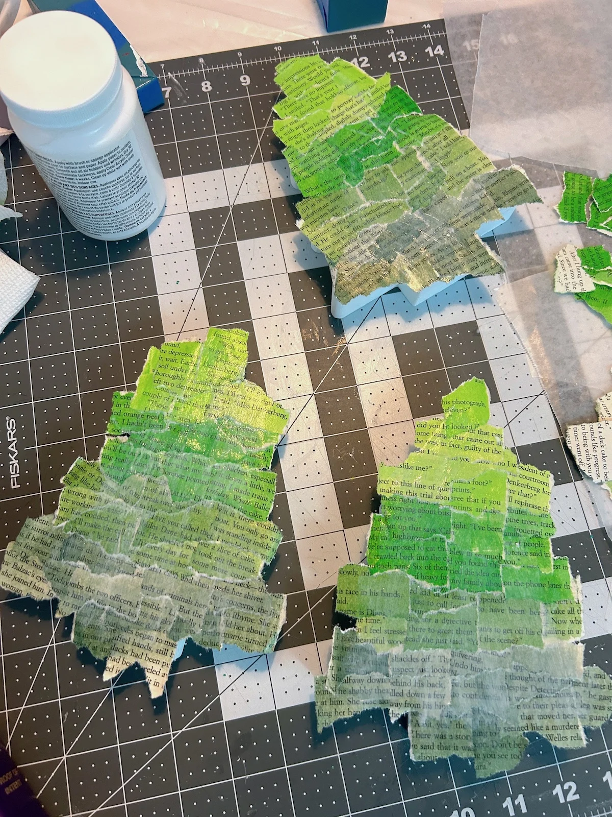wood trees covered in book pages and a second coat of Mod Podge
