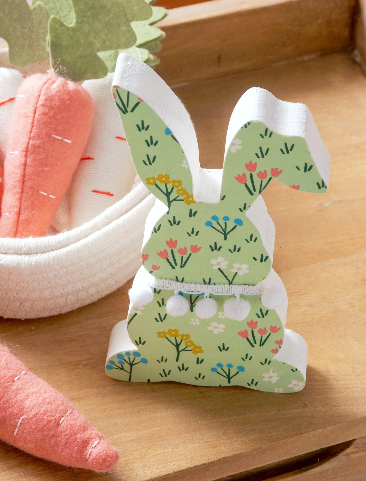 Decorating a wood bunny with napkins and Mod Podge