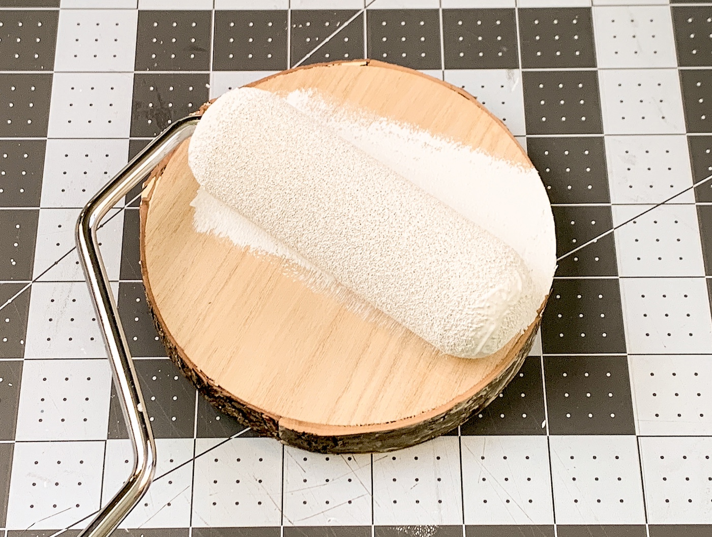 Painting a wood slice with white paint