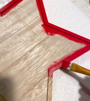 Painting the edges of the star with red paint
