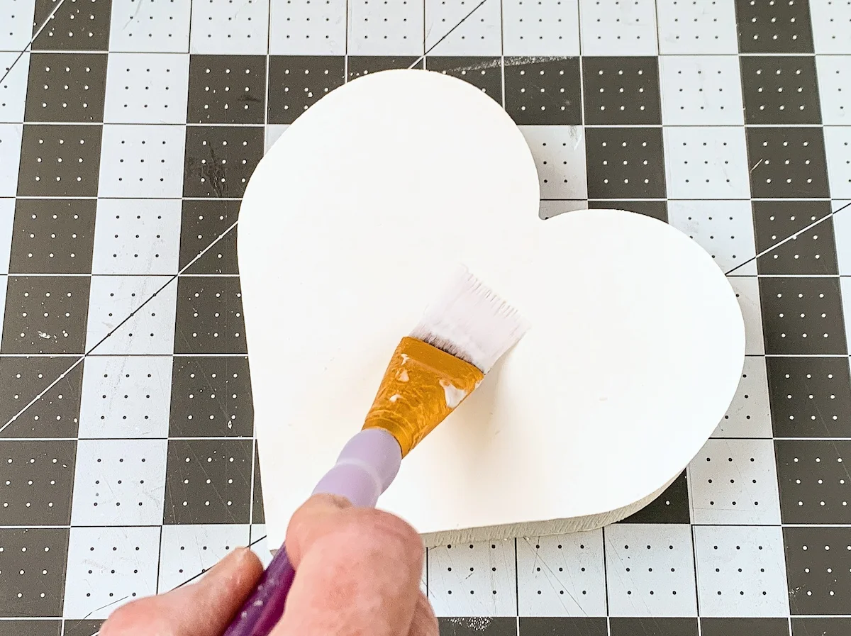 Applying two coats of Mod Podge to the top of the heart