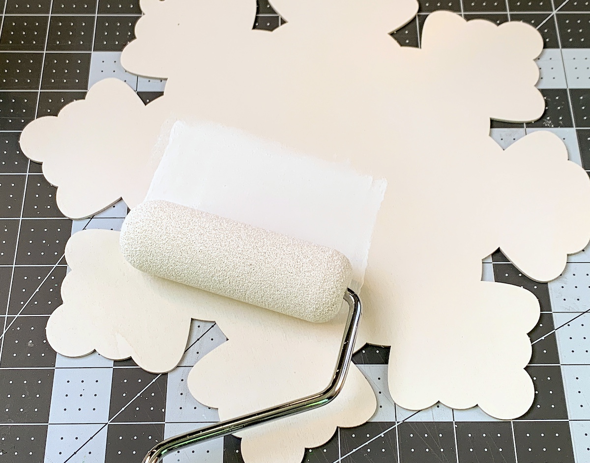 Painting a wood snowflake shape with white craft paint