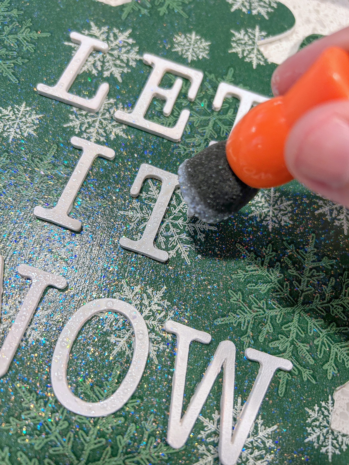 Painting the wood letters with white glitter paint