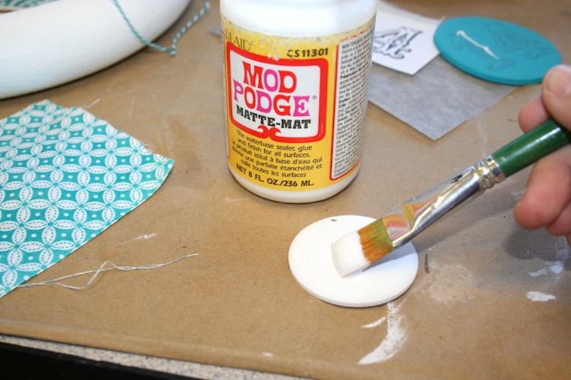Brush a layer of Mod Podge onto the wood pendant