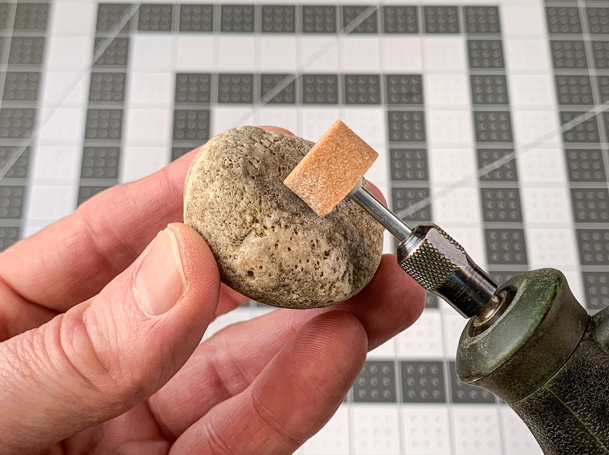 Sanding the top rock with a Dremel
