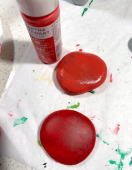 Painting round rocks with red paint