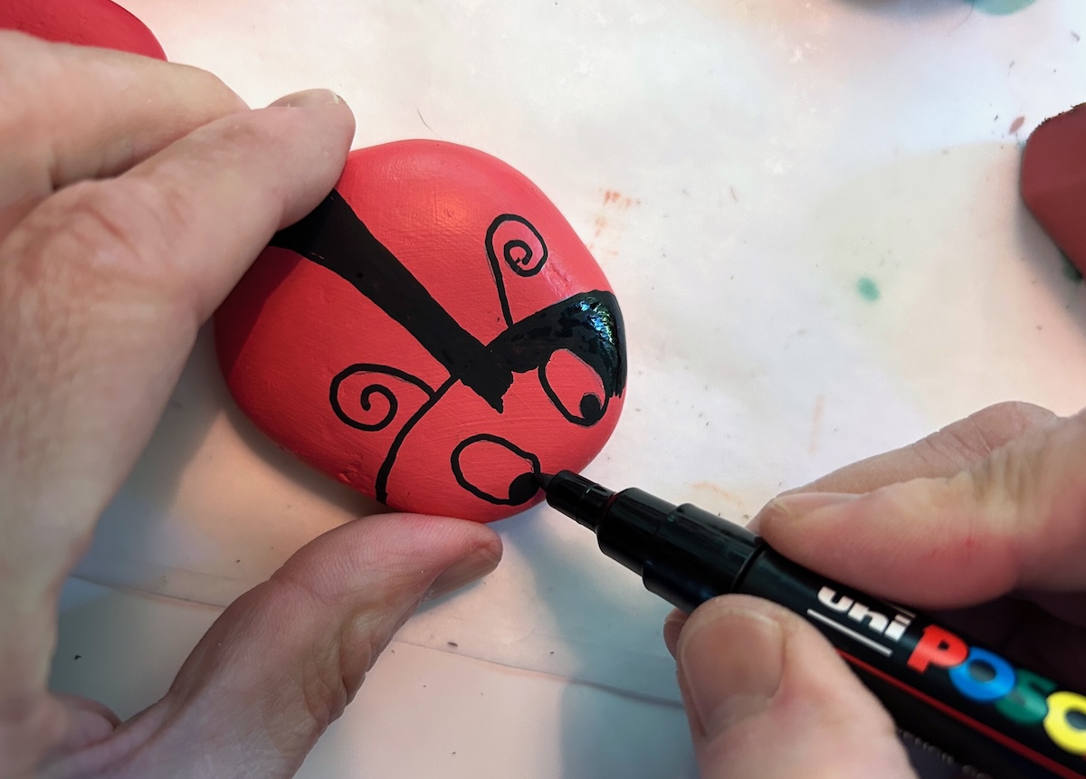 drawing on the dots and antennae with paint pens