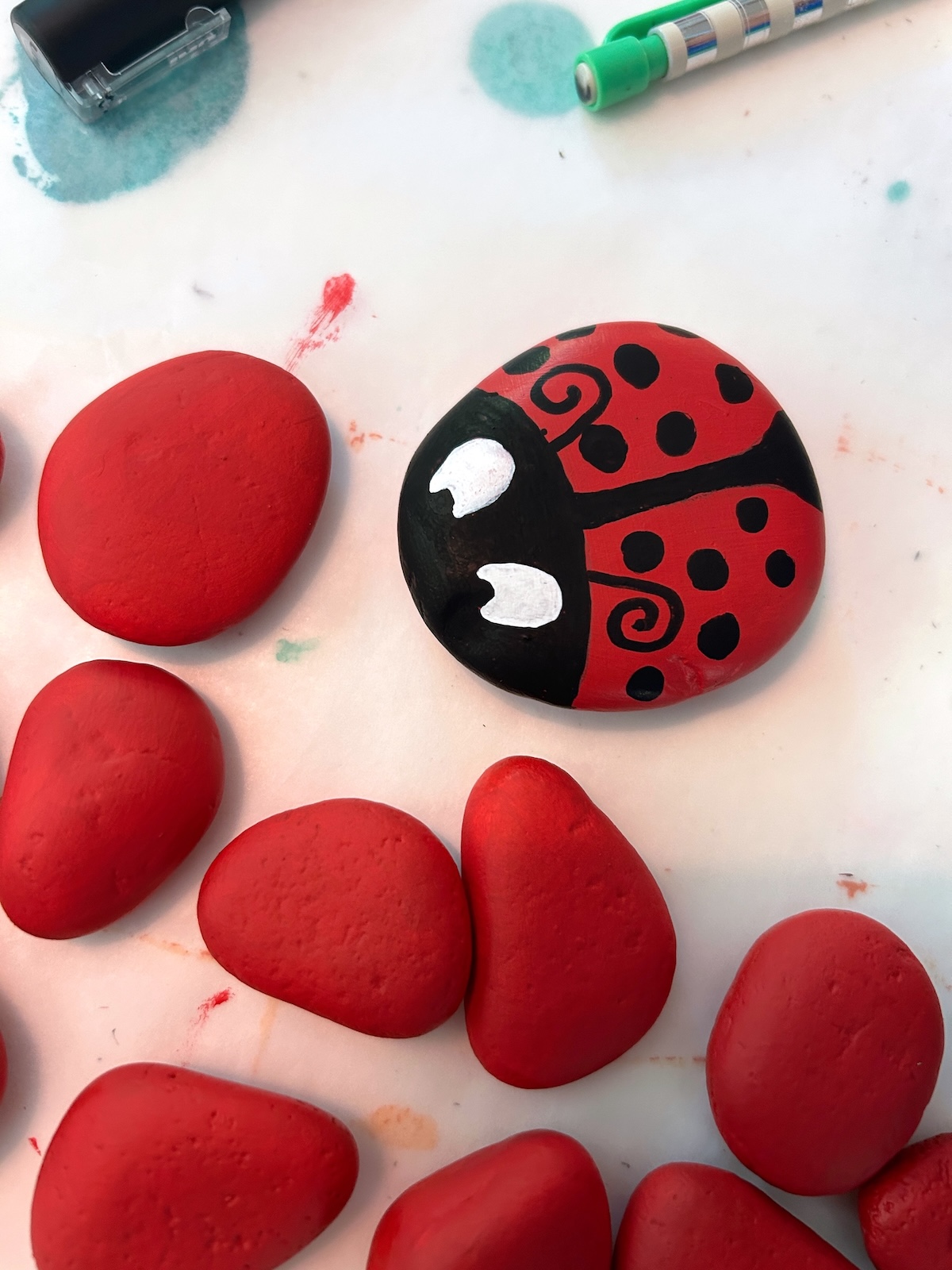 eyes drawn onto the ladybug rocks
