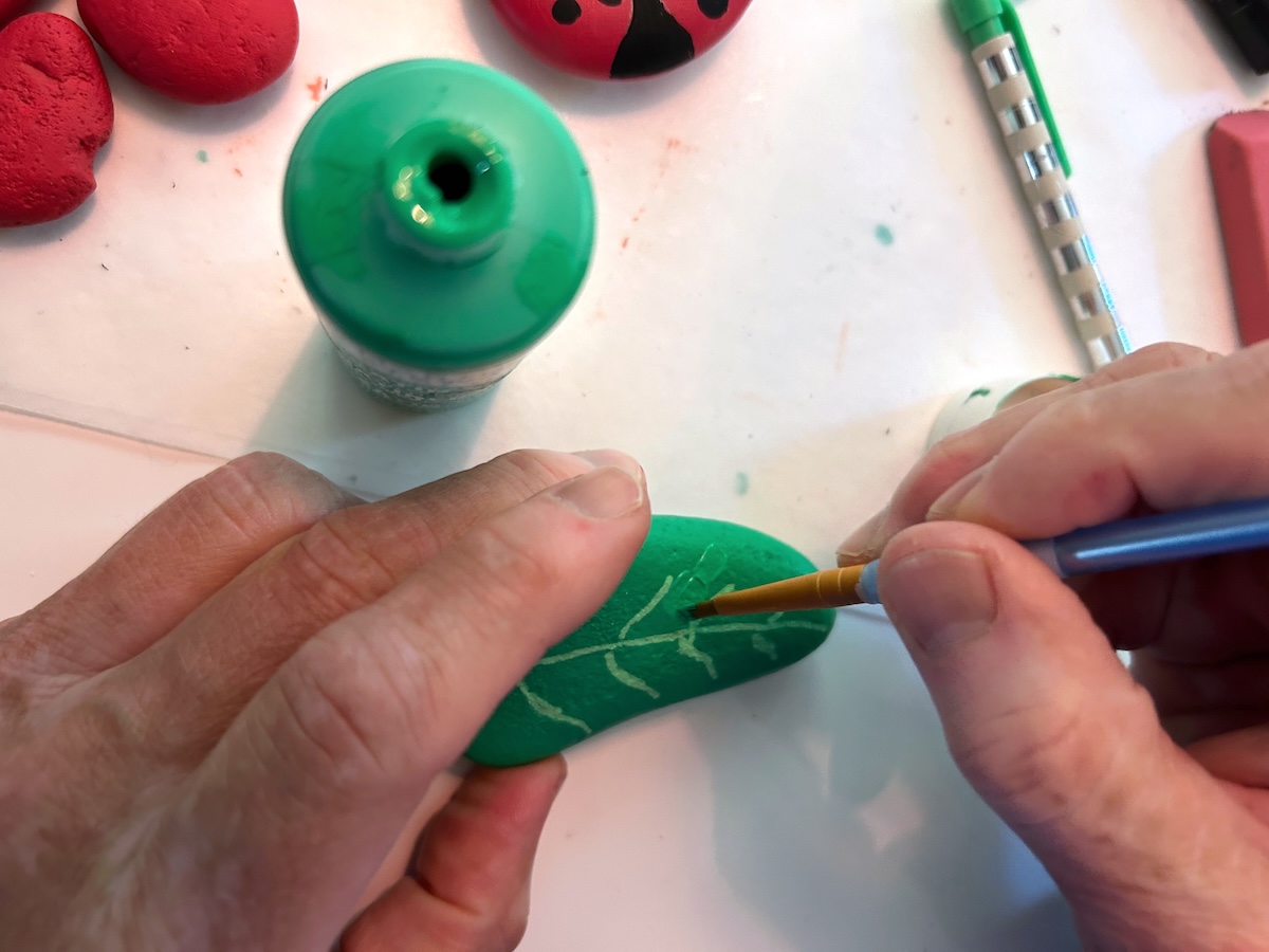 touching up the rocks with green paint