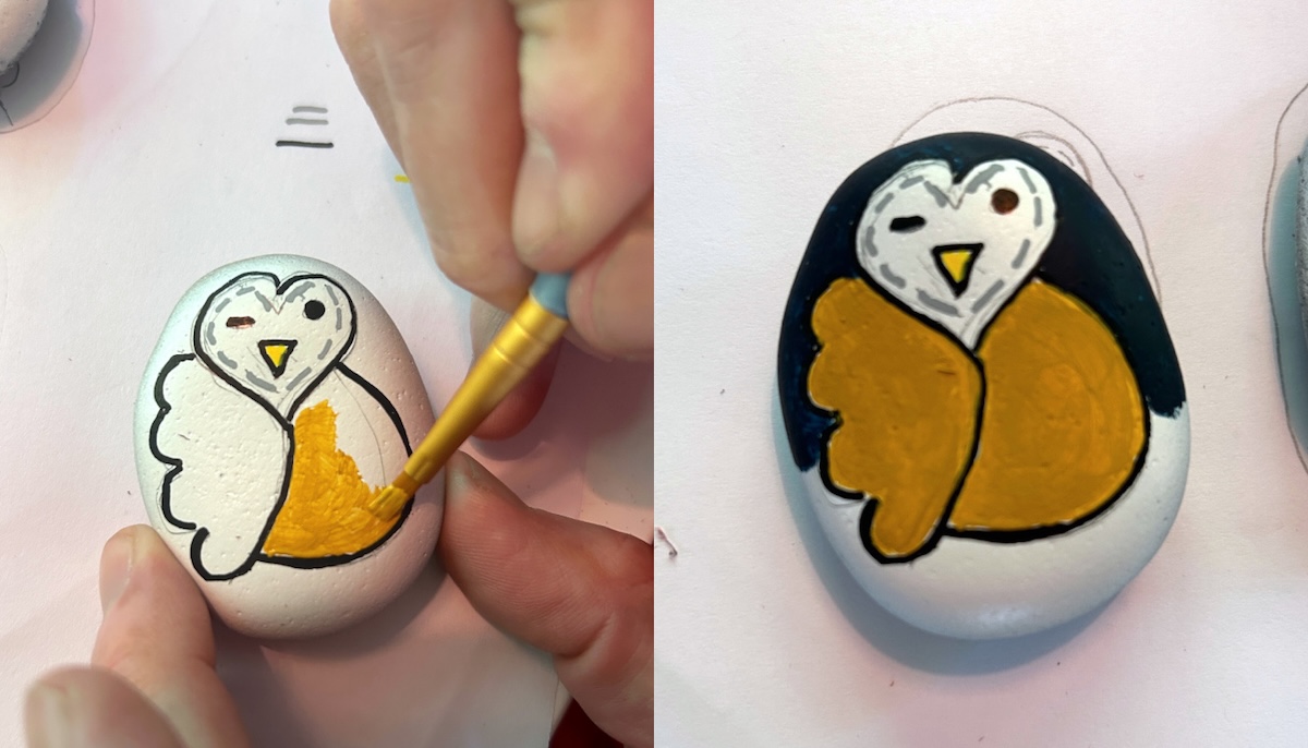 Painting the first layer of the design on the rocks