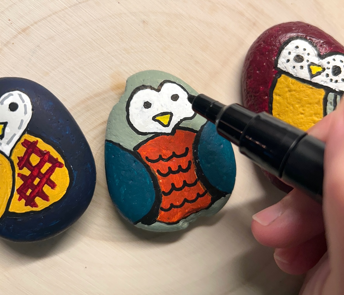 adding details to the design with paint pens